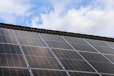 Photovoltaic panels capturing sunlight on a rooftop, generating clean energy for a sustainable futureの写真素材