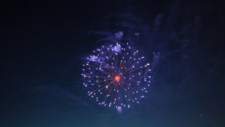Colorful fireworks exploding in the night sky, creating a spectacular display of light and color...