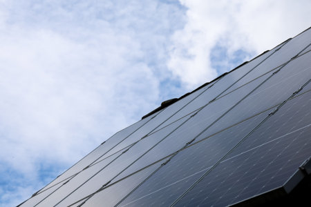 Photovoltaic panels are installed on a roof, converting solar energy into electricity, contributing to renewable energy and sustainable practicesの写真素材