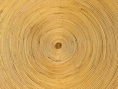 Close up of concentric circles creating mesmerizing pattern on rattan surface, showcasing natural...