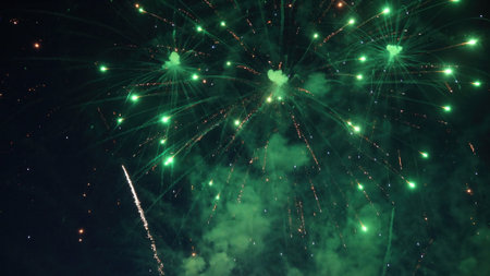 Bright green fireworks exploding during a nighttime celebration, illuminating the dark sky with...