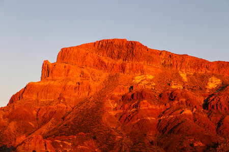 Volcanic rock formations at Roques de Garcia, Teide National Park bathed in warm golden hour light, dramatic red and orange tonesの写真素材
