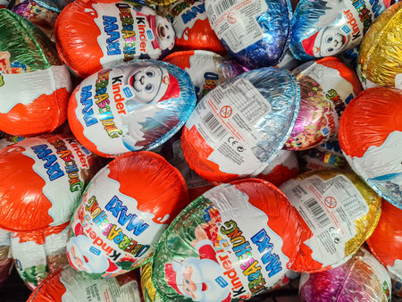 Kiel, Germany - 24. November 2025: Kinder Ãberraschung Maxi chocolate eggs filling the frame, featuring various festive designs for Christmas and winter holidaysのeditorial素材