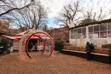 Kiel, Germany - 01. December 2025: People enjoying a traditional Christmas market in Kiel, Germany, with stalls, illuminated arch, and seasonal decorationsのeditorial素材
