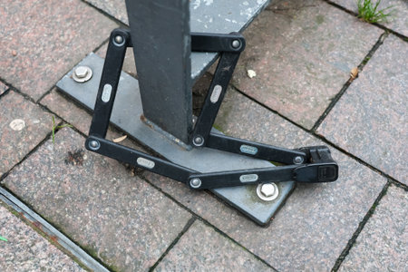 Flensburg, Germany - 21. December 2025: Foldable bike lock providing security for a public bike...