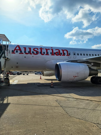 Naples, Italy - 09. March 2026: Austrian Airlines airplane parked on an airport tarmac with stairs...
