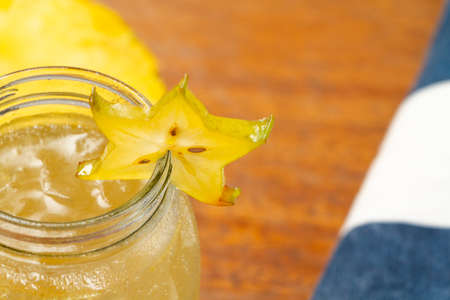 Star shaped yellow exotic fruit in glass juice glass