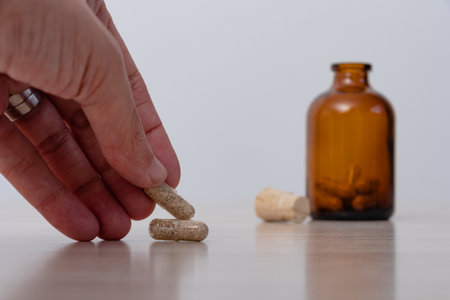 Woman's hand choosing psychedelic mushroom pill for her mental healthの写真素材