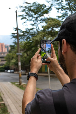 Experience the city through the lens of modern technology with this compelling photo of a man...