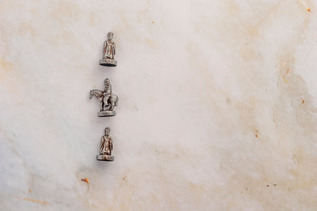 A high-contrast studio photograph of the complete physical Chinese Chess set. The brass and copper...