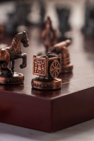 Focus on the Chariot Ju piece from a traditional Chinese chess set. The vintage copper texture...