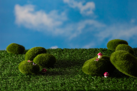 Whimsical Miniature World for Children's Toy Branding, A dreamy, nature-inspired miniature stage for toy photography. Features detailed mossy textures and whimsical elements that bring a sense of wonder to any kid-focused branding concept.の写真素材