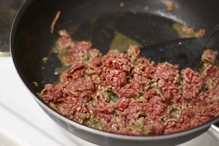 Restaurant cooking mince meat in frying panの写真素材