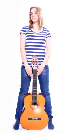 Studioshot of a young beautiful woman playing acoustic six-string guitar, isolated on white backgroundの写真素材