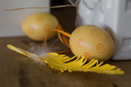 Close up of a yellow egg with feather, Easter Holidayの写真素材