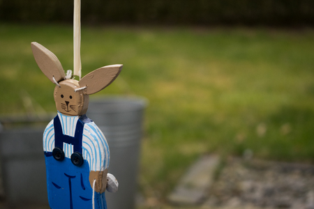 Easter bunny decorative hanging losely with green grass in backgroundの写真素材