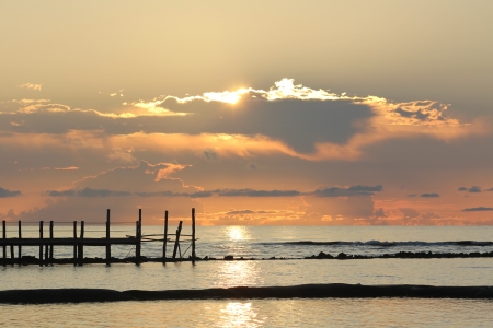 Fiery sunrise over a wooden pier at a tropical resort in the Mayan Riviera, Mexico の写真素材
