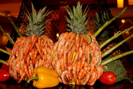 Peel and eat shrimp displayed as a pineapple sculpture on a buffet table の写真素材