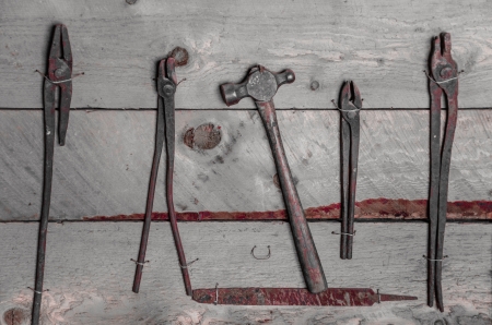 Black and white image with red paint of old hand tools are hanging on the wall of the barn at Fielding Garr Ranch on Antelope Island, Great Slat Lake, near Salt Lake City, Utah のeditorial素材