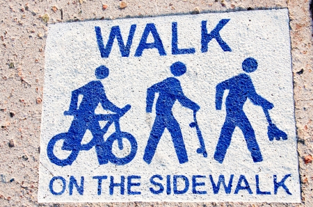 A Walk on the Sidewalk sign on the sidewalk in downtown Colorado Springs の写真素材