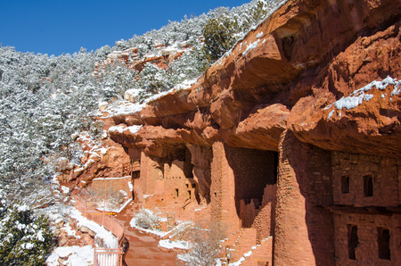 The amazing architecture of the Manitou Cliff Dwellings and fresh snow on a peaceful. sunny February morning.の写真素材