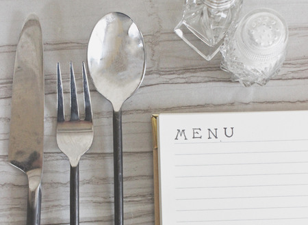 "menu" printed on blank paper with table settingの写真素材