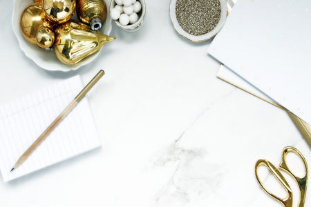 Elegantly styled Christmas desktop in white and gold. Copy space.の写真素材