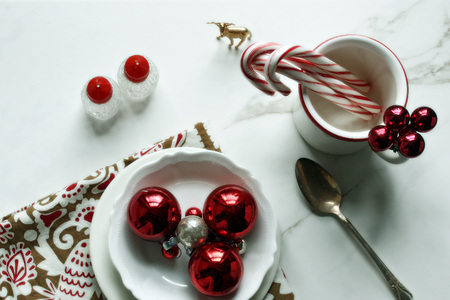 Christmas styled table setting with red and white decor.