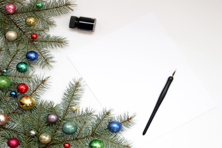 Pine branches with vintage ornaments, pen and ink with blank paper. Copy spaceの写真素材