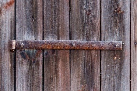 Iron hinge in a door of an old farm buildingの写真素材
