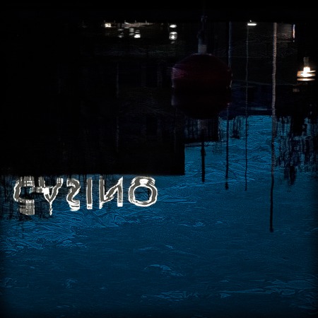 Casino lights reflecting from water by night の写真素材