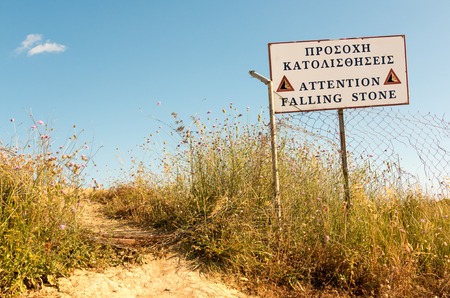 Warning sign at a dangerous cliff in Greeceの写真素材