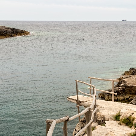 Wooden dock and a distant shoreの写真素材