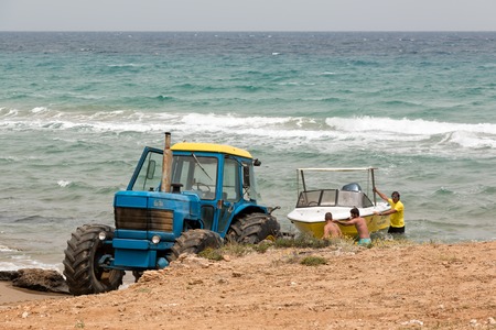 Tractor with a boat trailer towing a boat at Banana beach, Zakynthos, Greeceのeditorial素材