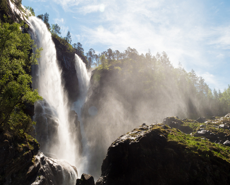 Water and mist spraying around a waterfall in Norway.の写真素材