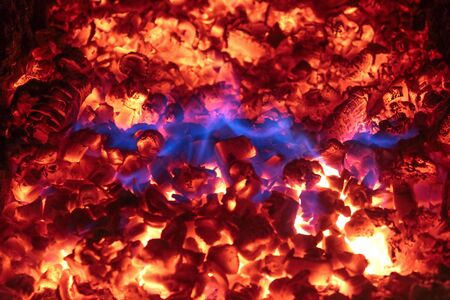 The texture of the coals red flames blue flamesの写真素材