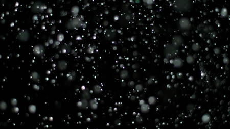 Snowfall Bokeh Lights on Black Background, Shot of Flying Snowflakes in the Airの写真素材
