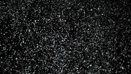 Snowfall Bokeh Lights on Black Background, Shot of Flying Snowflakes in the Airの写真素材