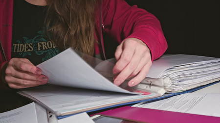 Woman with Documents Sitting on the Deskの写真素材