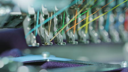 Embroidery machine starting to embroider with a needle on the fabricの写真素材