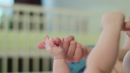 Close-up shot of babys little cute hand holding mothers loving hand.の写真素材