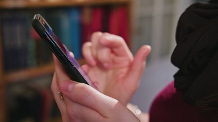 Woman hands using smartphone and internet search time.の写真素材