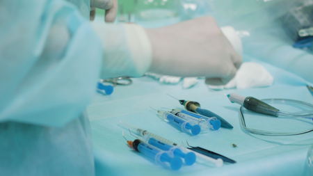 Hands of ophtalmology surgeons and assistants with ophtalomological surgery tools during surgical...