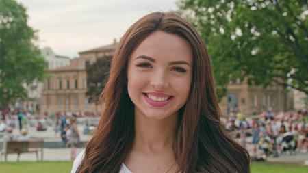A young beautiful elegant woman looking at the camera outdoors. Soft focusの写真素材