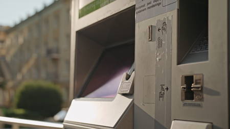 A young man using an ATM. Close-up shotの写真素材