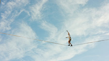 Lublin, Poland - July 2017: Slackliners in old town at Urban Highline Festival placed in old city space. Slackliner falls from the waving slackline. Sunny. Medium. Stabilizedのeditorial素材