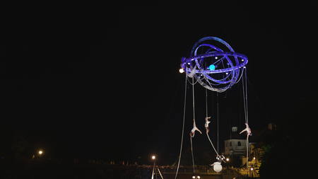 Lublin, Poland - July 2017: Acrobat dancers perfoming on the ropes outdoors at night. Long shotのeditorial素材