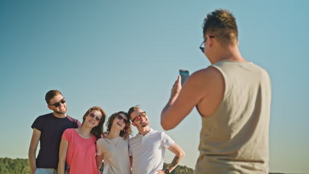 Young people posing for a photo on the beach. Medium shot. Soft Focus.の写真素材