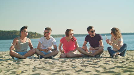 Young people having fun on the beach. Long shot. Soft Focus.