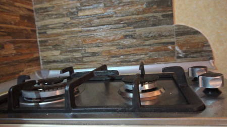 Turning on and off a stove burner in the kitchen. Close-up shotの写真素材